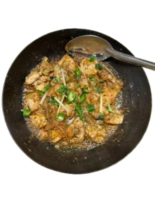 A Dish Of Chicken Charsi Karahi with chillies and ginger on top