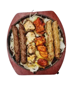 A BBQ platter featuring two seekh kebabs, two chicken seekh kebabs, two malai boti, and two chicken tikka boti.