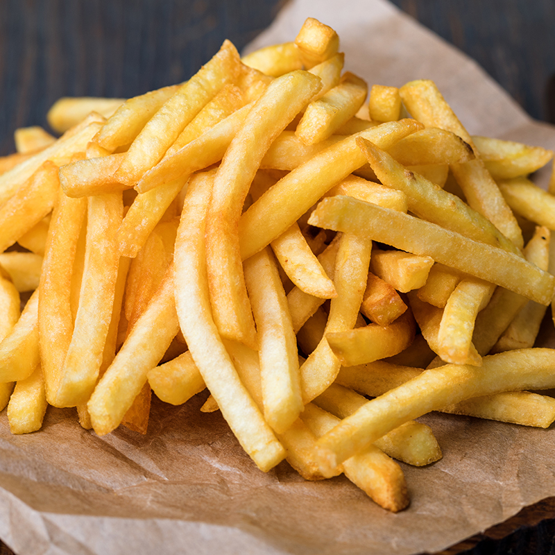 Golden crispy fries piled high on paper.
