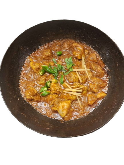 Delicious chicken karahi featuring succulent white meat, adorned with garnished chillies on top.