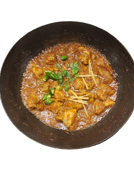 Delicious chicken karahi featuring succulent white meat, adorned with garnished chillies on top.