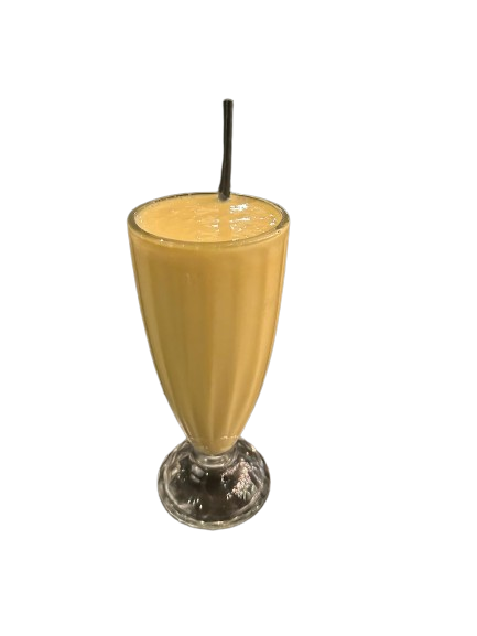 A glass of mango milkshake with straw