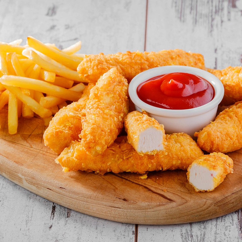 golden crispy chicken fingers served with fries and a side of ketchup dip sauce.