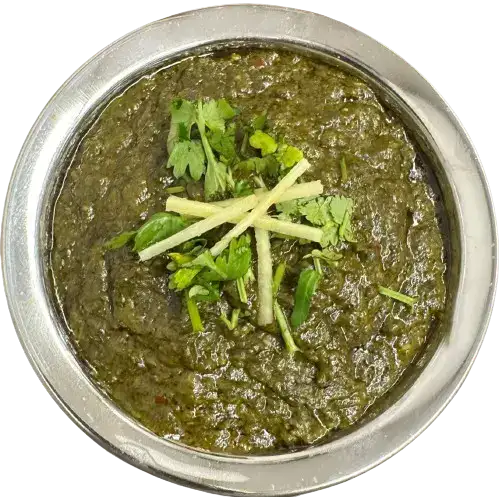 A Palak Gosht on plate with a touch of mint and garlic