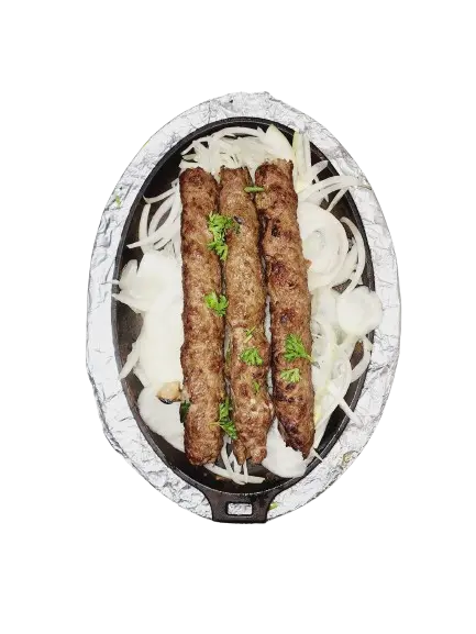 A tray of delicious three pieces of beef seekh kebab atop caramelized onions.