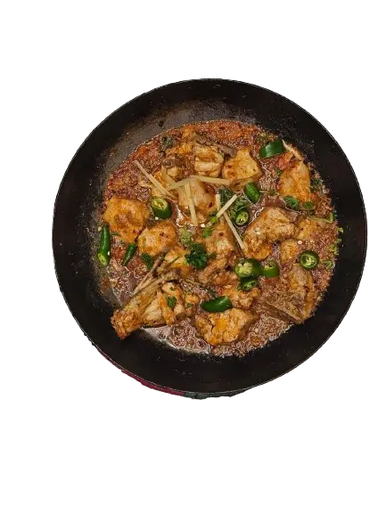 A chicken shinwari on black karahi with garlic and chilli topping