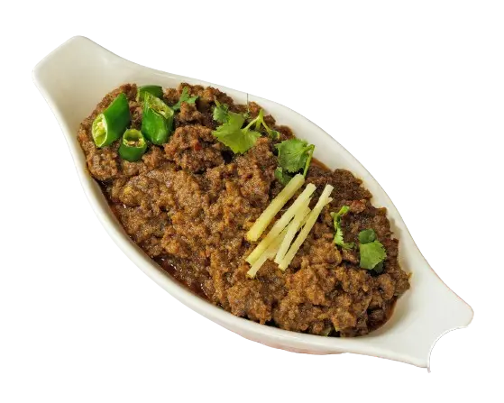 Tawa Qeema Beef, adorned with slices of chili and ginger, elegantly presented in a cylindrical dish.